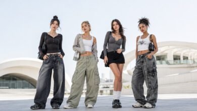 Diverse women wearing Acubi fashion outfits with baggy jeans, cargo pants, mini skirt, layered tops, chunky shoes, and silver accessories