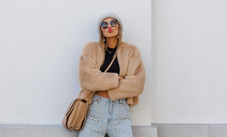 Stylish teen wearing a faux-fur jacket and crop top in winter street style