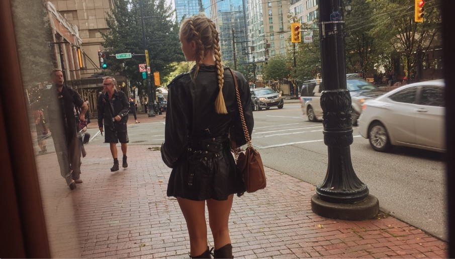 Black leather micro mini skirt styled in a modern city outfit, capturing micro mini skirts 2025 streetwear trends