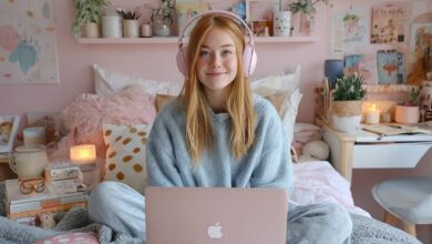 Teen girl looking at her laptop under candlelight representing emotional online comparison