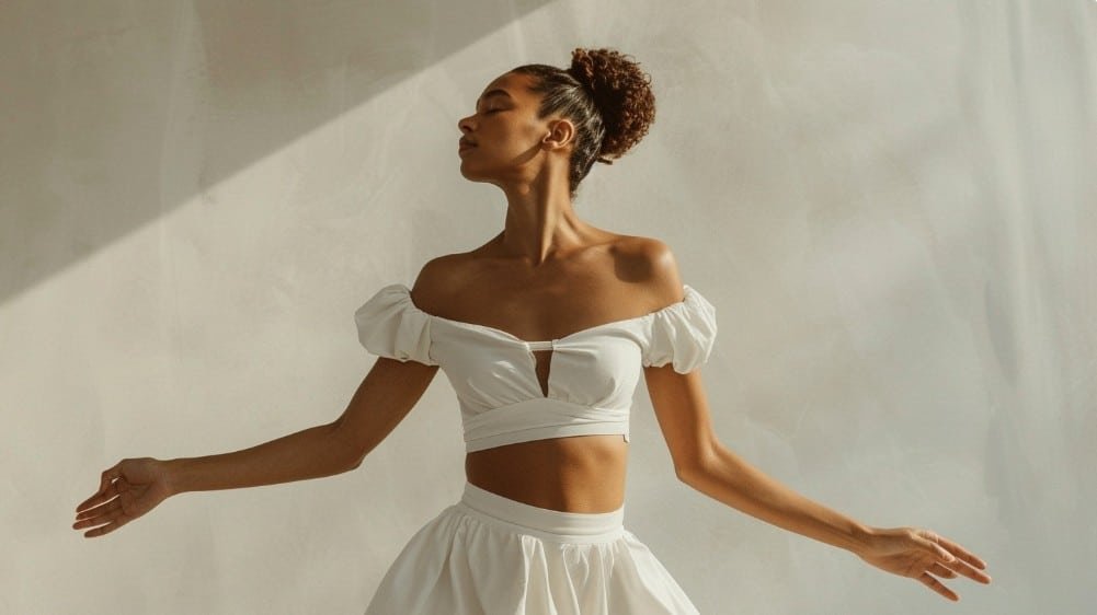 Close-up of babydoll top showing gathered under-bust seam and vertical volume release