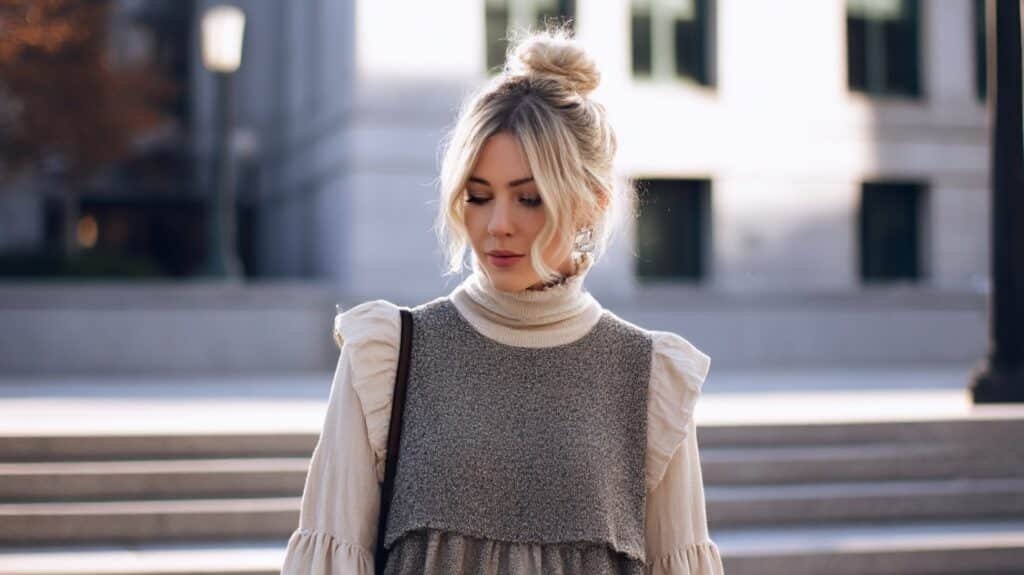 Layered babydoll top worn over a beige turtleneck for a cozy winter outfit