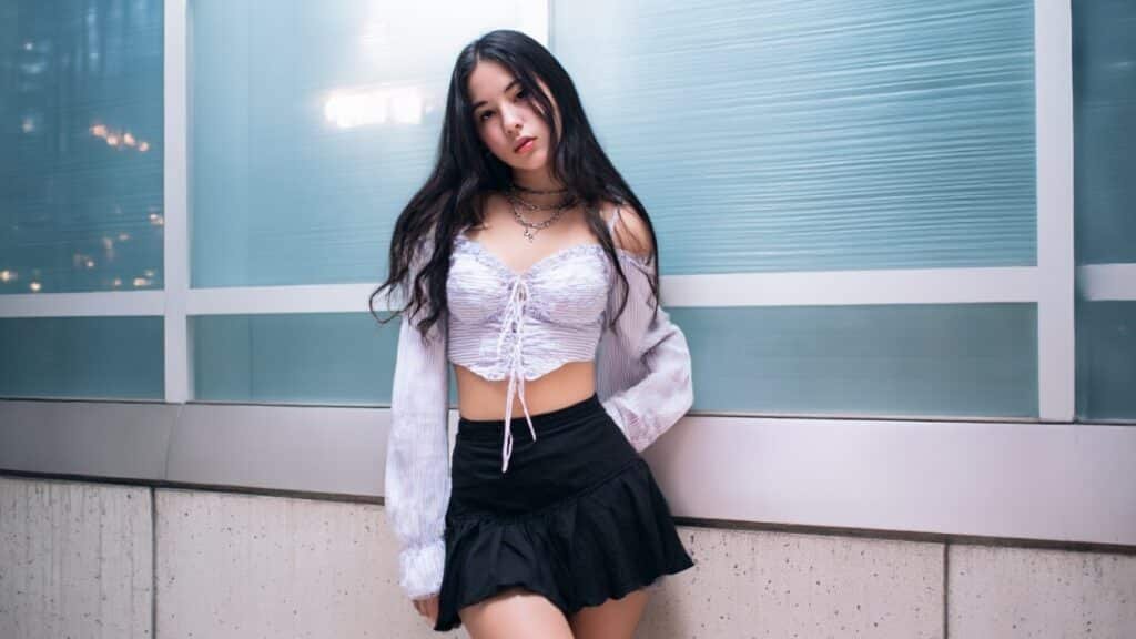 White ruched babydoll crop top styled with a black mini skirt