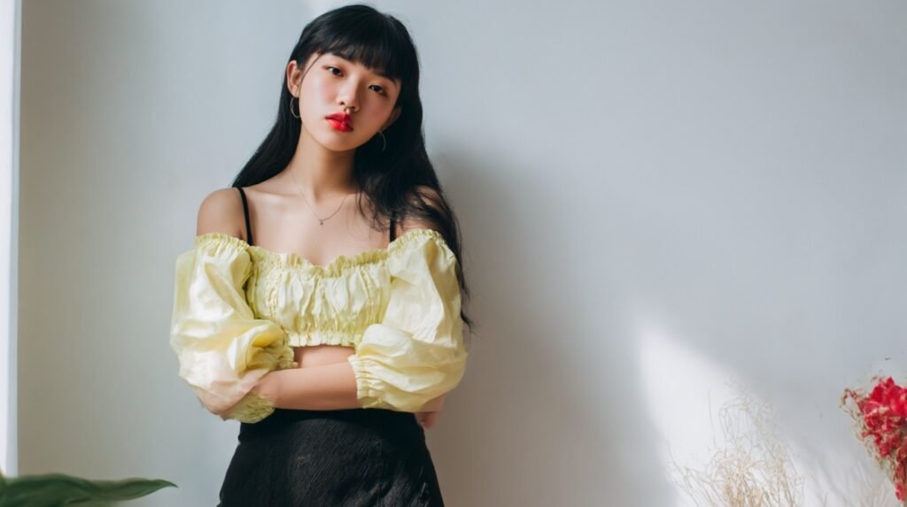 Yellow babydoll crop top with puff sleeves styled with a black skirt