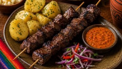 Bolivian anticucho de corazón with grilled beef heart, potatoes, spicy llajua and red onion