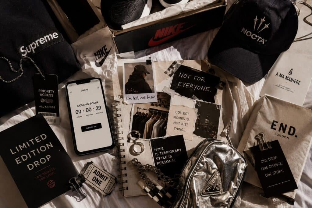 Why Limited Editions Make Everyone Suddenly Dramatic 3 Limited edition fashion drop flat lay with sneakers, hoodie, countdown phone, priority access tag, silver bag, jewelry, and streetwear collab moodboard