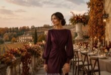October wedding guest dress in plum with long sleeves at an autumn vineyard terrace wedding