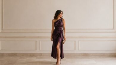 Unique wedding guest dress in plum satin with an elegant one-shoulder silhouette and polished styling
