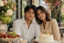 Teenage son celebrating his birthday with his mother, cake, flowers, fruit, and warm family support