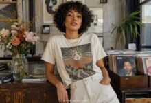 Stylish young woman wearing a vintage-inspired graphic tee with light denim in an artsy record shop, showing a cool casual outfit idea with personality.