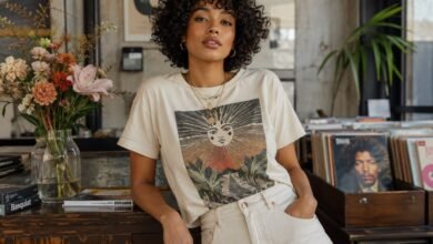 Stylish young woman wearing a vintage-inspired graphic tee with light denim in an artsy record shop, showing a cool casual outfit idea with personality.