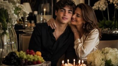 Proud mother celebrating her son’s birthday with cake, flowers, fruit, and a warm family moment