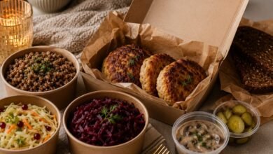 Russian kotleti takeout with buckwheat, beet salad, cabbage salad, mushroom sauce, pickles and rye bread for a cozy Eastern European dinner