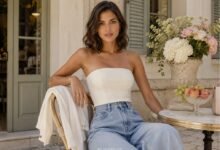 Strapless top outfit with light denim jeans, soft cardigan, gold jewelry, flowers, fruit, and relaxed café style inspiration