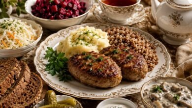 Russian kotleti dinner with mashed potatoes, buckwheat, beet salad, cabbage salad, mushroom sauce, sour cream, pickles, rye bread and tea