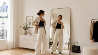 Woman checking outfit proportions in a mirror to understand why the look feels unbalanced