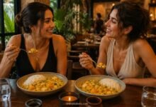 wo stylish women eating traditional Peruvian locro de zapallo with white rice at a Peruvian restaurant