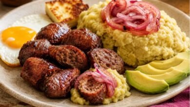Dominican longaniza frita with mangú red onions avocado and breakfast sides