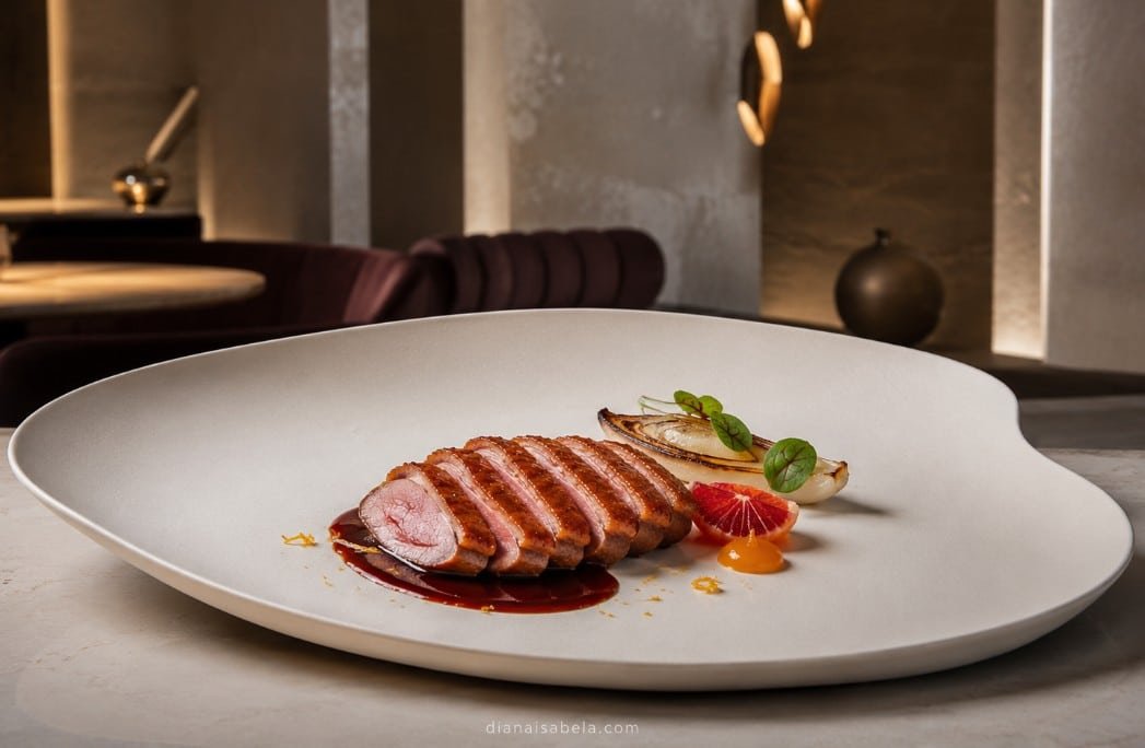 Modern citrus-driven duck à l’orange in a contemporary restaurant