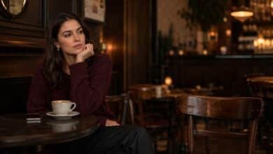 Woman sitting alone in a café reflecting on unequal effort in dating