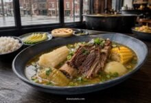 Colombian sancocho de costilla with beef rib, yuca, green plantain and corn served in a warm Chicago Colombian restaurant