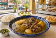 Colombian oxtail sancocho with yuca, green plantain, corn, rice and avocado in a bright New Jersey Colombian restaurant
