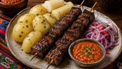 Bolivian anticuchos with grilled beef heart, potatoes, yuca, peanut llajua and red onion