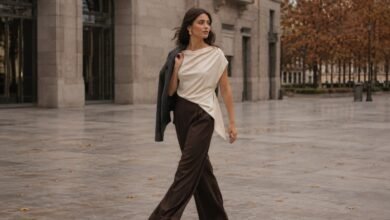Stylish woman walking through a modern city plaza in a fluid outfit that shows natural fabric movement